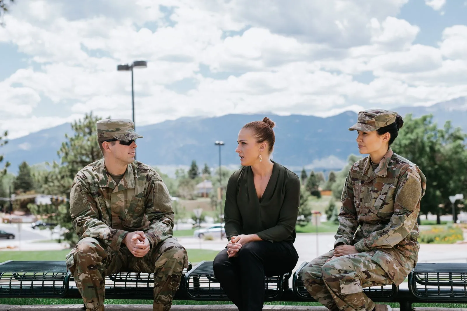 Military students talking to advisor outside on campus