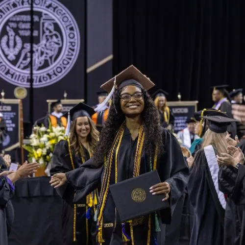 A 2025 UCCS graduate with her diploma