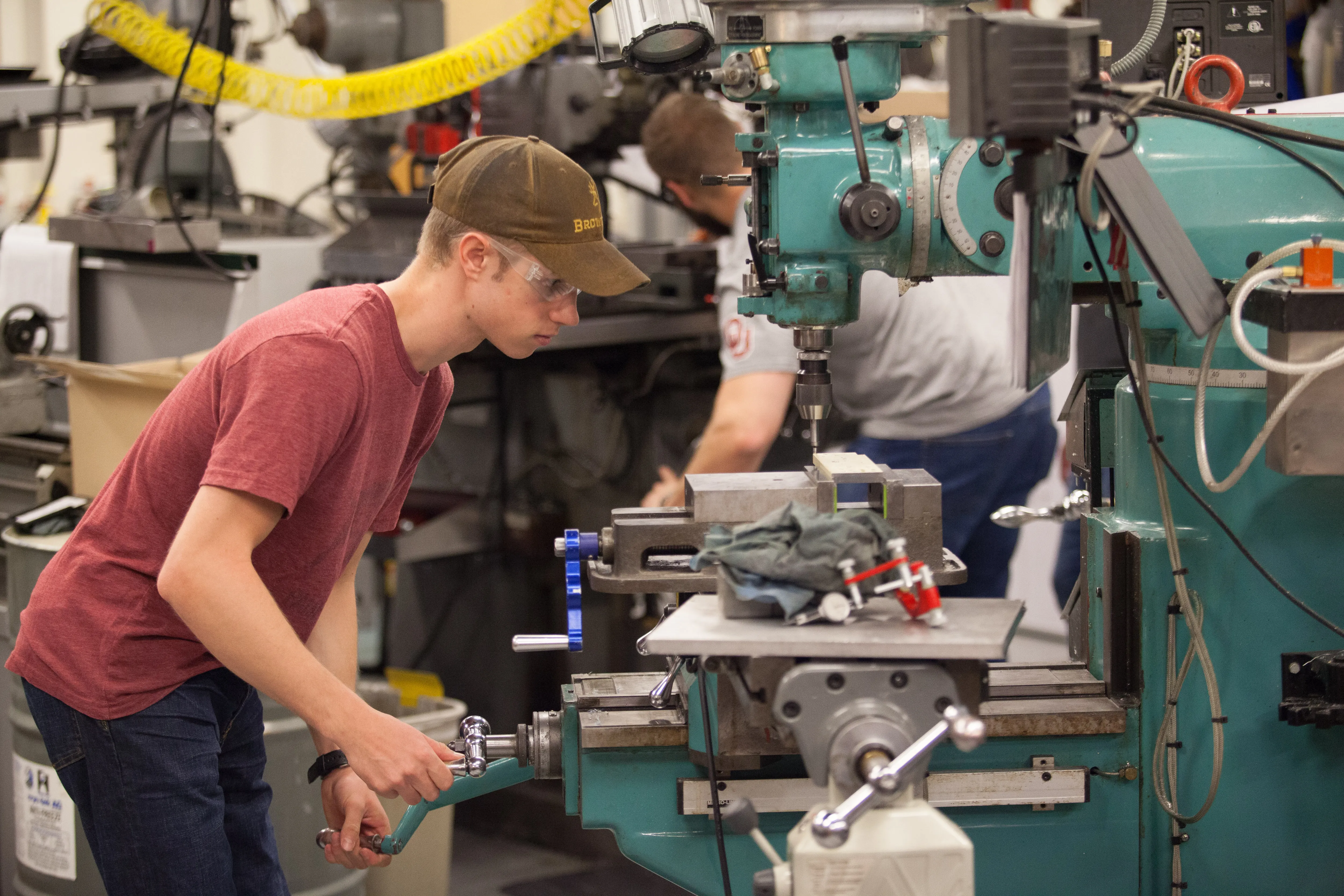 student using machine shop tools